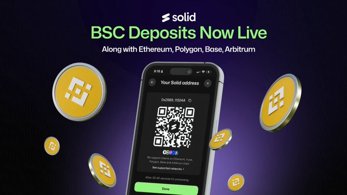 The image shows a smartphone screen displaying a QR code, which appears to be a Bitcoin wallet address. The text on the screen reads "BSC deposits are now live on Solid Fund your account with BNB Chain in seconds. More flexibility. Less friction. Start funding today". This suggests that the user has recently deposited Bitcoins using the provided Bitcoin wallet address and is now promoting the ease of use, quick transactions, and low fees associated with this method of payment.