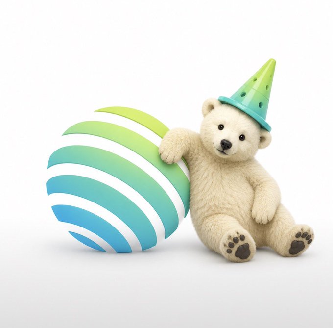 A cute white teddy bear wearing a small green and blue party hat sits against a green-to-blue striped beach ball on a white background.