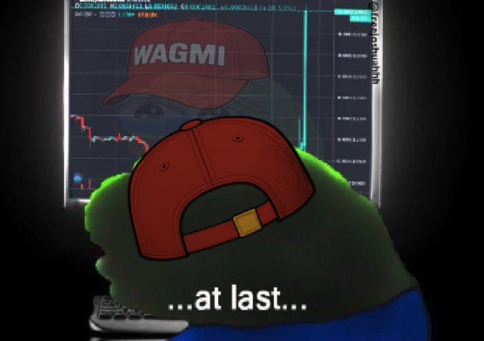 A crypto meme featuring the 'WAGMI' (We're All Gonna Make It) red cap character (Pepe) in front of a trading chart, with the text '...at last...' at the bottom, suggesting a price recovery.