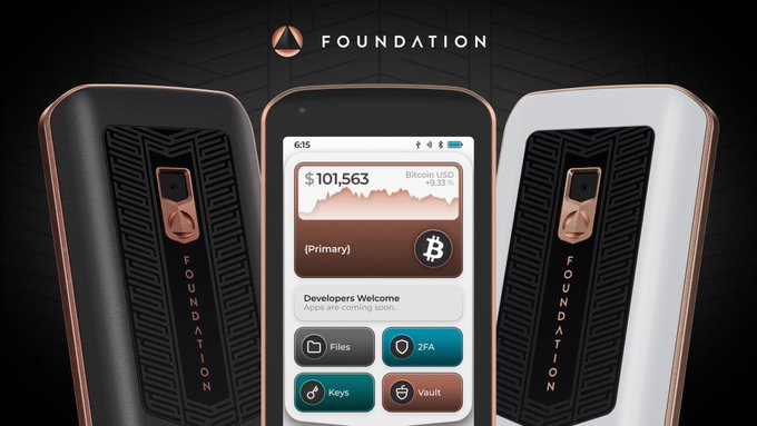 Three Foundation cryptocurrency hardware wallets displayed, with the middle one showing a Bitcoin balance of $101,563 and menu options for Files, 2FA, Keys, and Vault.