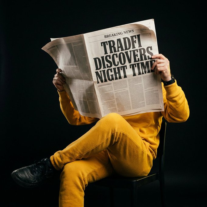 A person in a yellow tracksuit sits with legs crossed while holding up a newspaper with the bold headline "TRADFI DISCOVERS NIGHT TIME" under "BREAKING NEWS," completely obscuring their face in a dramatic, editorial-style pose. The image humorously highlights the crypto community's playful jab at traditional finance ("TradFi") slowly catching on to round-the-clock trading, tying into the post's tongue-in-cheek question about whether these "discoveries" also apply to weekends.