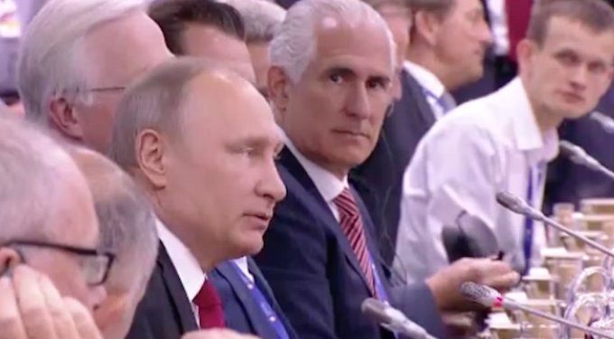 Vladimir Putin and other officials are seated at a conference table, listening intently. The gathering reflects Russia’s recent decision to allow retail investors to trade Bitcoin, Ethereum and USDT on regulated exchanges beginning September 1.