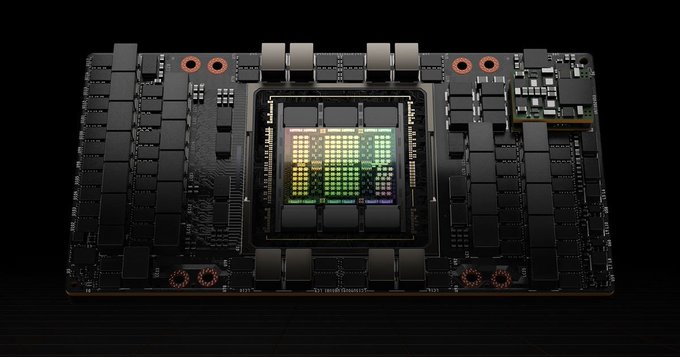 A top-down view of a graphics processing unit (GPU) circuit board with a glowing chip at its center. The image relates to the post by symbolizing the "$H100 ticker" mentioned in the text, representing a name that ties into the GPU's naming convention.