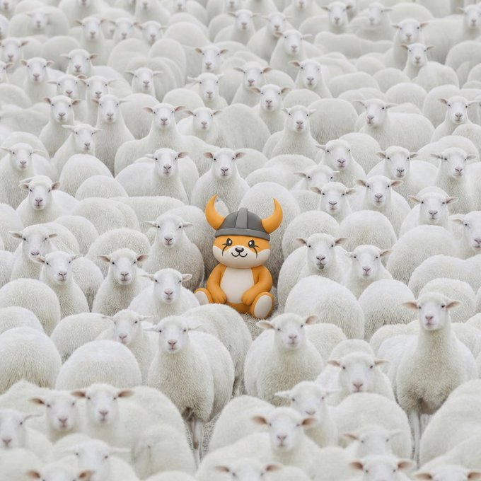 A small plush Viking-helmeted dog (resembling the Floki mascot) sits at the center of a vast flock of identical white sheep, perfectly illustrating the post's message to "Be different" and stand out from the crowd with $FLOKI.