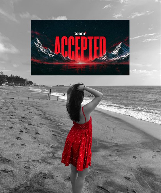 A black and white photo of a woman in a red polka dot dress on a beach looking at the ocean, with a "team ACCEPTED" graphic overlaid.