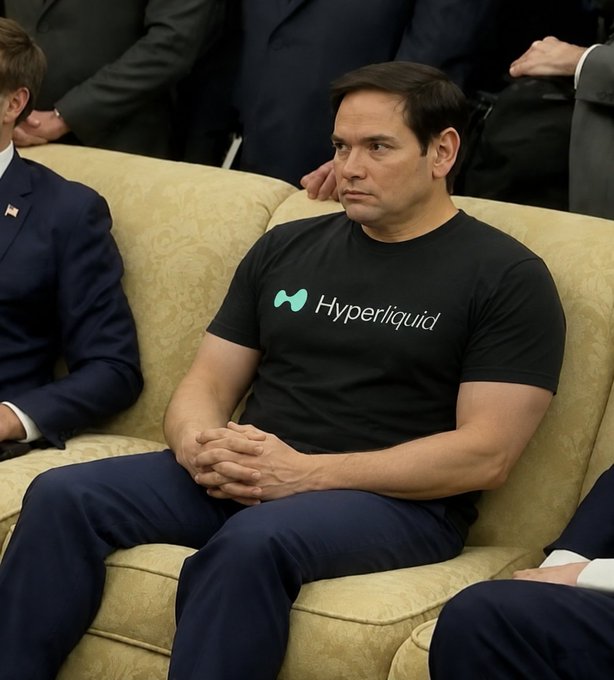 Marco Rubio sits on a couch wearing a black "Hyperliquid" t-shirt, appearing shocked or concerned, seemingly reacting to the news that he has become a validator on the Hyperliquid platform. The humor lies in his visibly bewildered expression paired with the crypto-branded apparel, humorously suggesting his surprise at this unexpected role.
