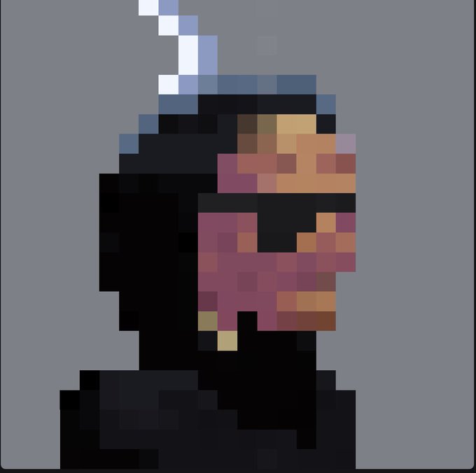 A heavily pixelated, low-resolution image showing a figure with dark clothing and a pinkish-red face or mask against a gray background.