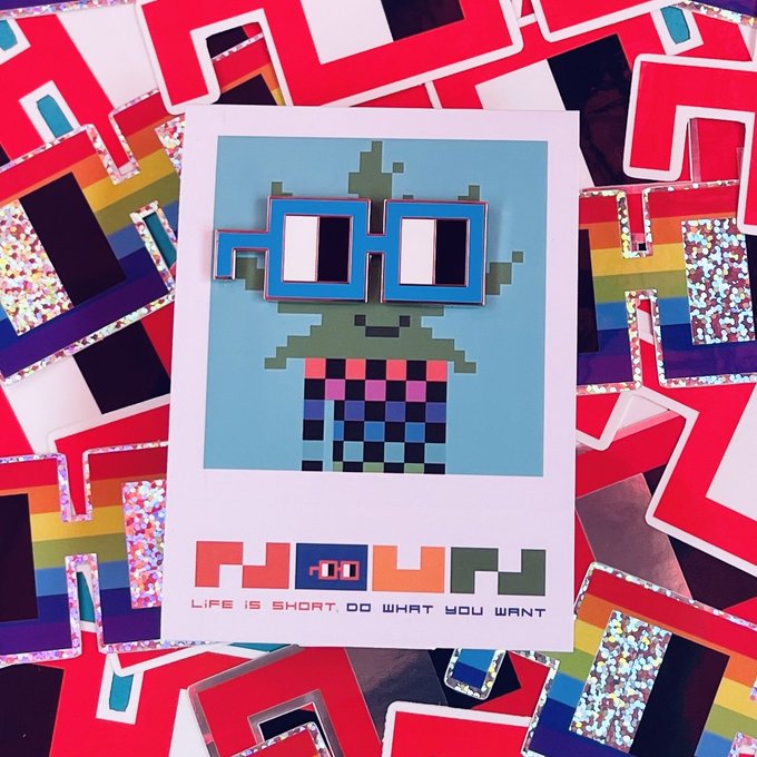 A collection of stickers and a sticker sheet featuring a pixel-art character with a checkered shirt and blue pixel glasses; the sheet reads 'NOW' and 'LIFE IS SHORT. DO WHAT YOU WANT.'