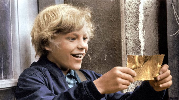 A smiling young boy with tousled blonde hair holds up a crinkled golden ticket, his eyes wide with excitement as he examines it against a weathered stone wall.

The golden ticket he's proudly displaying embodies the post's theme of something unexpected and valuable rising "up and to the right"—a rare discovery that demands everyone take notice and figure out what's happening.