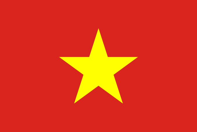 The image shows the flag of Vietnam, featuring a large yellow five-pointed star centered on a red background. The flag relates to the news as Vietnam is set to impose fines of up to $1,900 on crypto traders using unauthorized platforms, effective September 1.