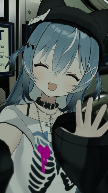 An anime-style illustration of a blue-haired girl with a skeleton-patterned shirt, black beanie, and cross hairpins, smiling with her eyes closed while waving at the camera.