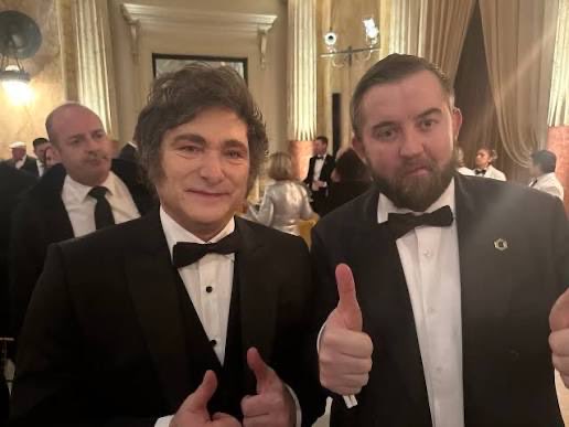 Two men in black tuxedos with bow ties give thumbs-up gestures at a formal event, with the context referencing Chainlink ($LINK) and its onchain solutions for AI and Argentina. The image likely depicts a Chainlink-affiliated individual posing with Argentina's President Javier Milei at an official gathering.