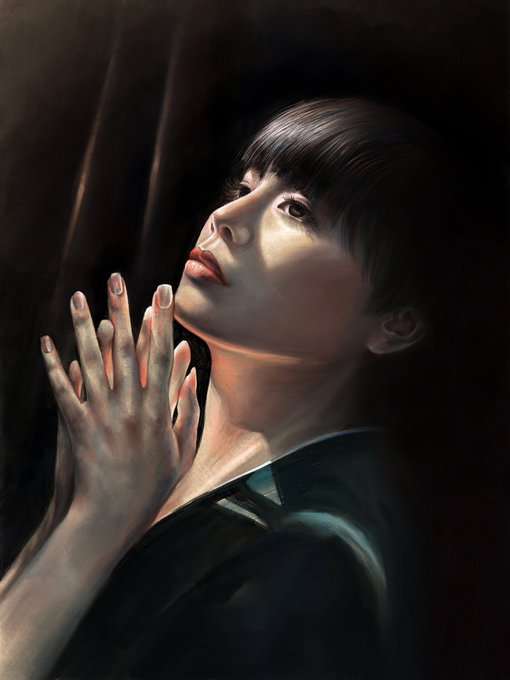 A hyper-realistic painting of a young woman with short black hair looking upward, her hands gently raised with red-painted nails catching the light against a dark background.
