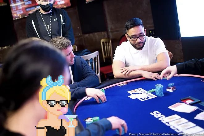 A group of men play poker at a blue-felt table in what appears to be a casino or poker room, with a pixel-art sunglasses-wearing character overlaid in the bottom left corner; the image is credited to 'Danny Maxwell/Rational Intellectual Holdings Limited'.