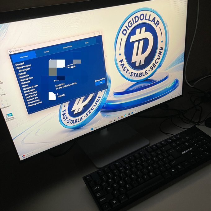 A computer monitor displaying the 'DIGIDOLLAR' wallet application interface with options like 'Send', 'Receive', and 'Network Tools', next to a Greenon brand keyboard.
