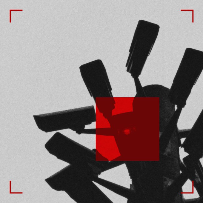 A stylized black-and-white illustration of surveillance cameras features a large red square graphic in the center.