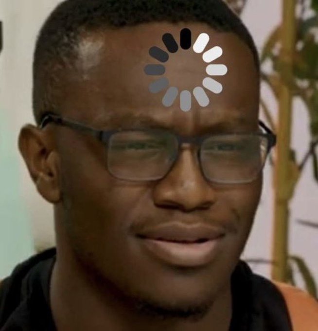 A man with short hair and glasses wears a loading symbol overlaid on his forehead.