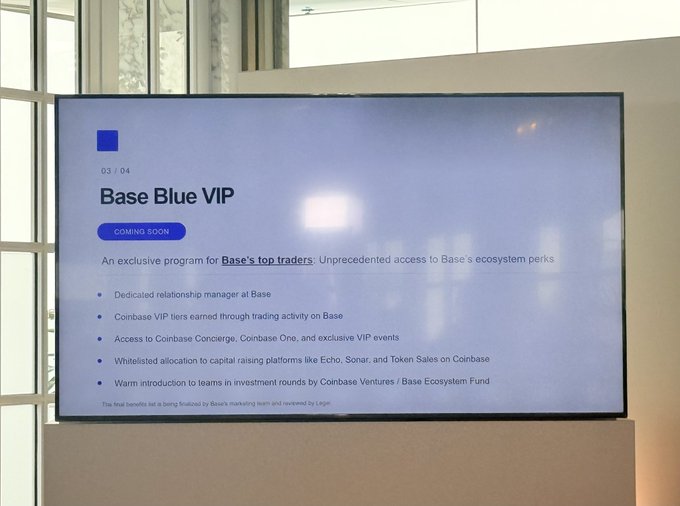 A wall-mounted TV displays a 'Base Blue VIP' (Coming Soon) presentation slide describing an exclusive program for Base's top traders with perks like dedicated relationship managers and access to Coinbase Concierge.