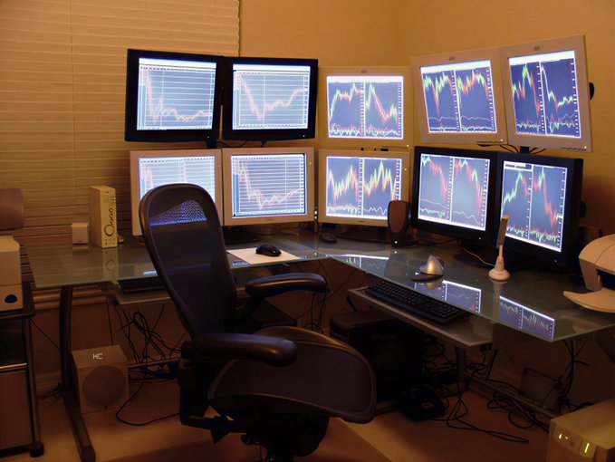 The image shows an office desk with multiple computer monitors, including four screens arranged in two rows of two. There are also several keyboards and mice placed on the desk for use by the employees. The room appears to be a workspace or office environment where people work together using computers and other technology. The post suggests that these workers will benefit from this setup, as they can view multiple screens simultaneously, which could lead to increased productivity and efficiency in their jobs.