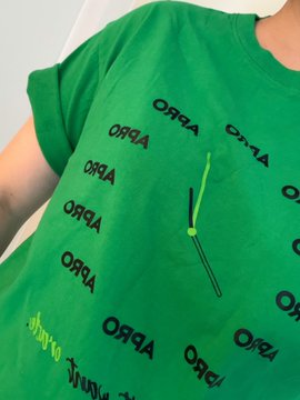A close-up shot of a person wearing a vibrant green t-shirt featuring the "ORQA" logo repeated in a bold black font, along with a neon green zip detail on the chest. The image reflects the casual, community-focused spirit of the post, showing the speaker's branded attire as they head to BNB Seoul to connect with the community.