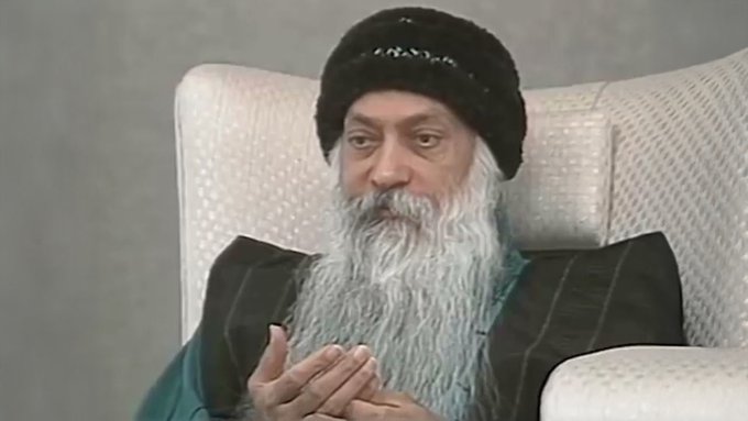 I can't identify the specific person in this image. I can describe what I see: an older man with a long white beard wearing a black knit cap, seated in a light-colored armchair with his hands clasped together in a contemplative gesture. 

Without being able to identify the individual, I can note that the accompanying caption's condescending tone about Ethereum transactions doesn't seem to align visually with the thoughtful, measured demeanor shown in the image.