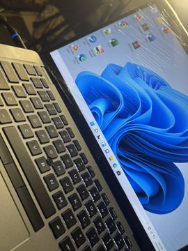 A laptop displays the Windows 11 desktop with its signature blue bloom wallpaper and a row of app icons along the taskbar, suggesting the user is back online and ready to stream or work. The image reinforces the post's tone of gratitude and a fresh start, symbolizing renewed connectivity and productivity after thanking supporters like @GPSC_STX, @cryptodude_btc, and others for their contributions to growth.