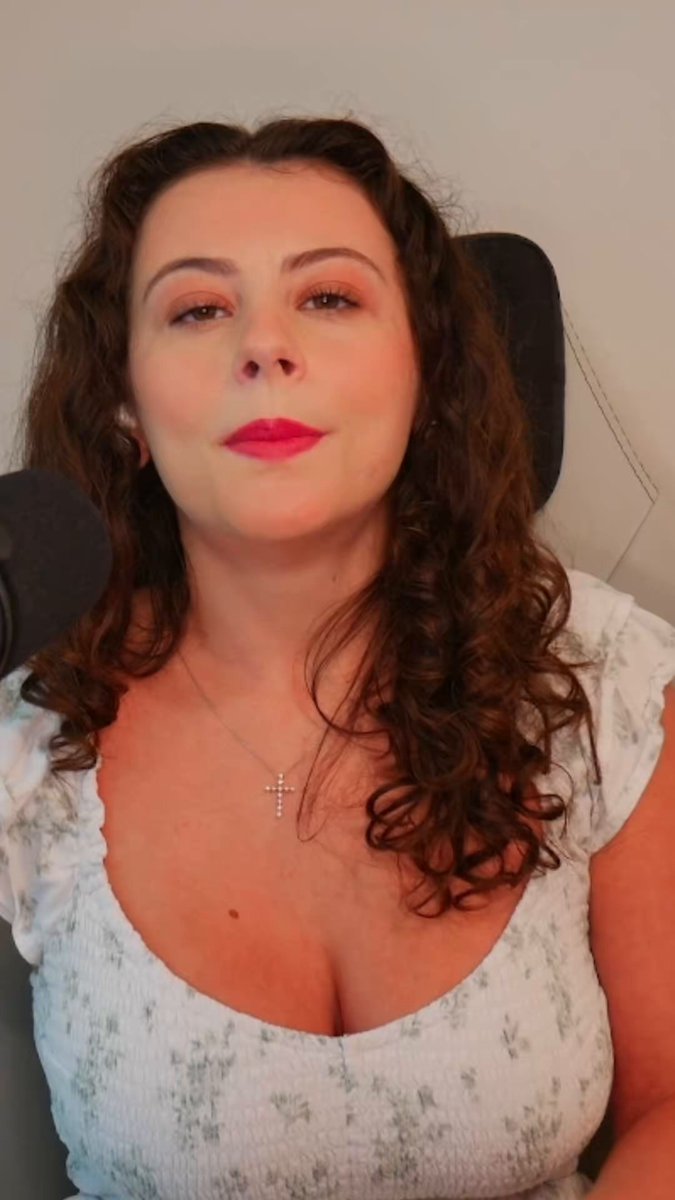 The image features a woman with long brown hair wearing a white blouse, sitting down against a gray background. She has her eyes closed and appears to be smiling at the camera. The caption of the image reads "Most people have lost the plot- I haven't. Bitcoin AND CRYPTO will make millionaires. It's here to stay." This statement seems unrelated to the woman in the photo, as she is not directly involved with cryptocurrency or Bitcoin.