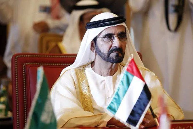 A man wearing traditional Gulf attire sits at what appears to be an official meeting, with the UAE flag visible in the foreground, lending visual authority to the post's announcement that property purchases using Bitcoin and cryptocurrency are now possible in the UAE.
