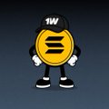 A small cartoon mascot character featuring a round yellow body with an 'S' symbol, wearing a black cap with '1W' and black clothing, stands against a dark background.