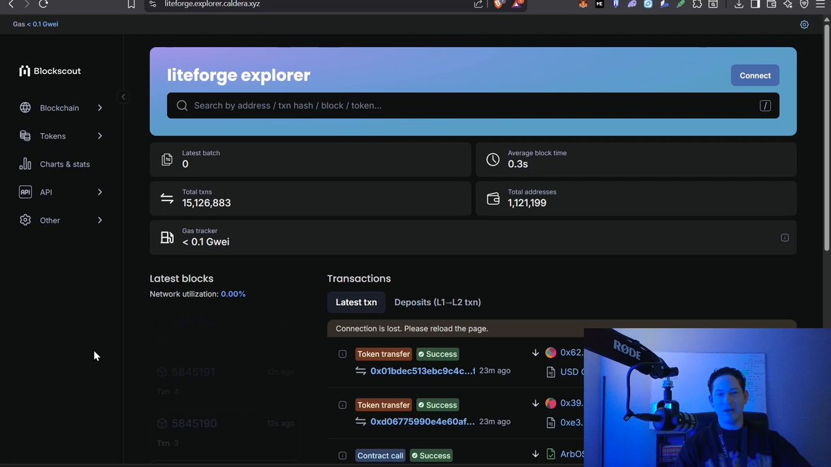 The image shows a computer screen displaying a webpage with information about Litecoin. The main focus of the image is a person's face sitting behind the computer monitor, likely the host or presenter of the content displayed on the screen.