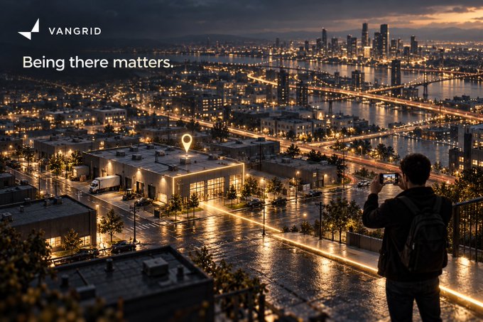 A cinematic promotional image for 'VANGRID' with the tagline 'Being there matters.' depicts a nighttime cityscape where a person takes a photo of a highlighted building with a location pin marker.