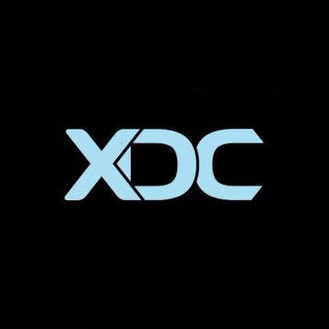The image displays the XDC logo in light blue on a black background, representing the XDC Network brand highlighted in the announcement of its new XDC AI launch.