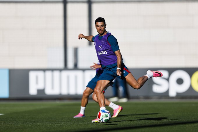 The image features a soccer player kicking a sports ball across a field while wearing a purple shirt with the word "Puma" written on it. The background of the photo shows a wall, suggesting that they are taking place at a soccer training facility or stadium. The caption in the image reads "Will you be watching the GOAT play in the World Cup, @cz_binance". This implies that there might be an upcoming soccer event where the player is known for his skills and achievements, possibly related to the World Cup.