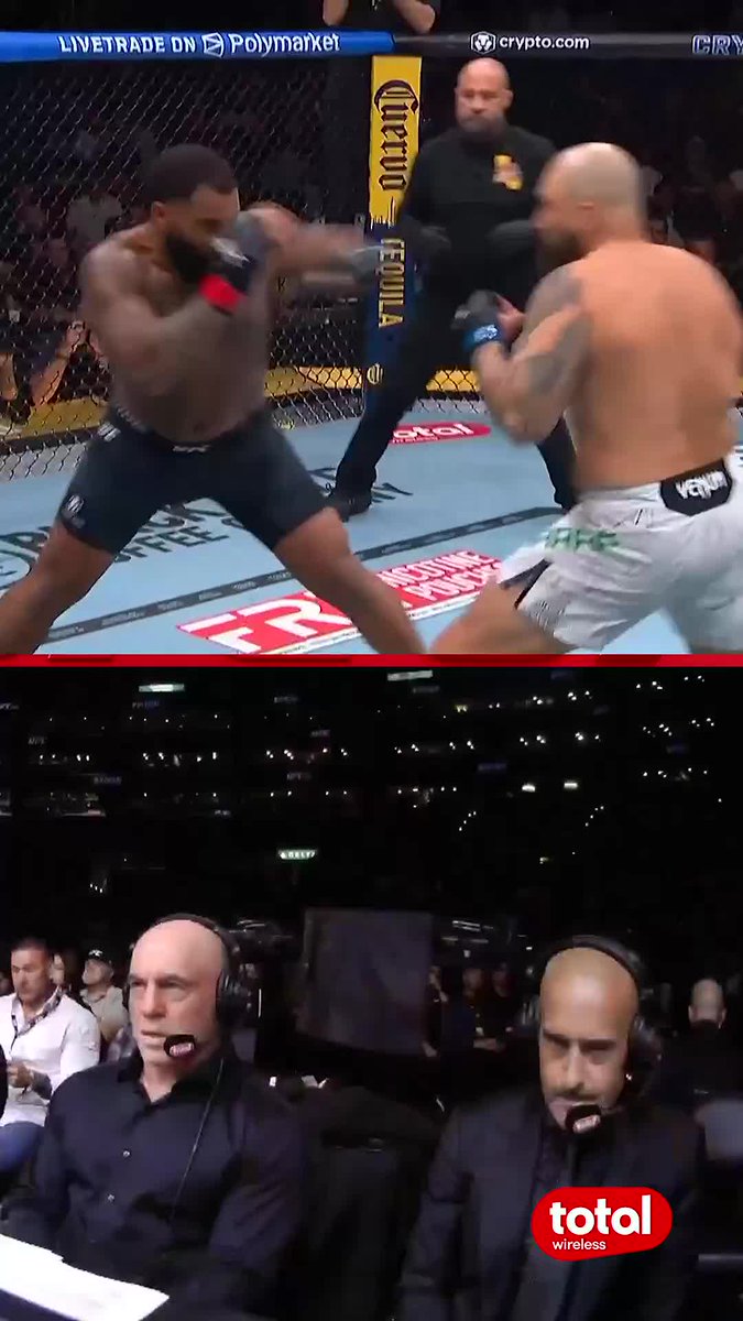 In the top portion of this split-screen image, two UFC fighters exchange strikes inside the octagon, with visible sponsor logos including "LIVE TRADE ON Polymarket," "crypto.com," "Cuervo Tequila," and "Modelo" on the cage padding and mat. The bottom half shows two bald commentators wearing headsets at the broadcast desk, while a "total wireless" logo appears in the lower right corner. The caption "Bitboy is back" humorously references Ben "Bitboy" Armstrong's rumored return to crypto commentary, paired with this UFC fight scene—likely suggesting Armstrong is back in the spotlight "throwing punches" in the crypto space just as the fighters are trading blows in the octagon.