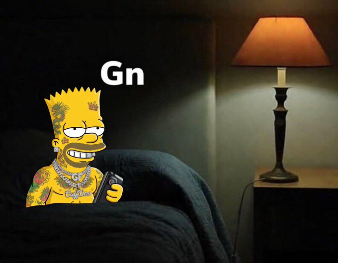A meme featuring Bart Simpson covered in tattoos and jewelry, sitting on a dark couch and using a phone in a dimly lit room with 'Gn' written above him. A warm-lit lamp sits on a side table next to him.