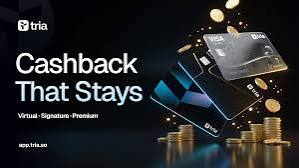 The image features a black background with three stacks of gold coins scattered around it. The text "Cashback That Stays" is written above the coins, while the phrase "@useTria" appears below them. This suggests that the image might be related to an advertisement or promotional material for a virtual currency called @useTria.