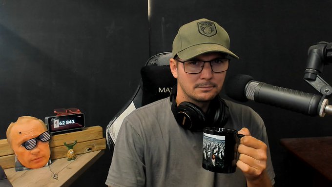 A man wearing a "Federal" cap and glasses sits in a podcast studio holding a mug, with a headset around his neck and a microphone in front of him, next to a radio displaying "62.843." The image accompanies a post apologizing for not covering the Coldcard scandal while the host is away from the studio, noting that Trezor coverage should be unaffected.