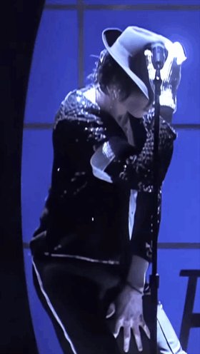 The image features a man dressed in a black outfit, wearing a hat and holding a microphone close to his face. The background of the photo has a blue color with white lines running across it. There are also some words visible in the image that read "LTC #LTC $LTC #Litecoin Very exciting! We're almost there folks! Those with diamond hands will reap the rewards ( I think those are really Michael Jackson's gloves)." The man is positioned on a stage, and his attire suggests he might be performing or participating in an event related to Michael Jackson.