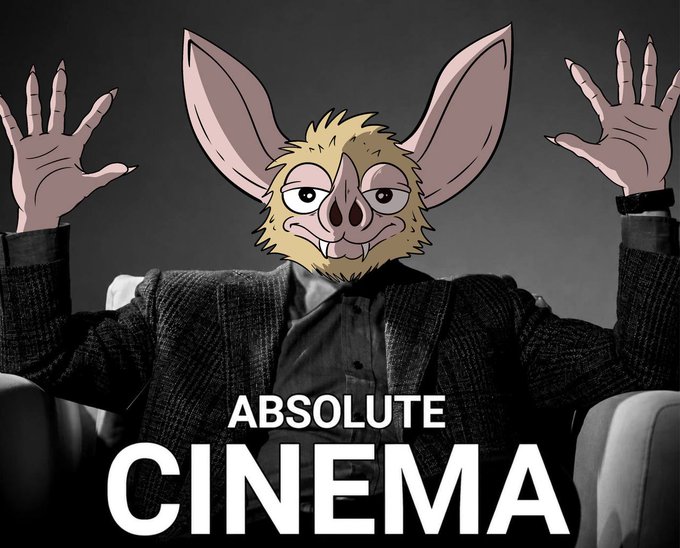 A person in a dark suit sits in a chair with both hands raised dramatically, their face replaced by an illustration of a wide-eyed, bat-eared creature, with bold white text below reading "ABSOLUTE CINEMA." The meme captures the feeling of declaring something masterful right at the beginning of a journey, as the caption "just getting started" suggests the creator is hyping their upcoming work as cinematic from the very first moment.
