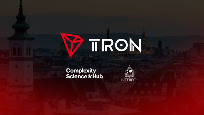 A promotional image for TRON blockchain featuring the TRON logo over a darkened cityscape, with 'Complexity Science Hub' and 'INTERPOL' logos at the bottom.
