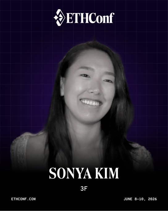 The image features a woman with long hair smiling at the camera. The background of the image is purple, which contrasts with her black hair. She appears to be a speaker or presenter for an event related to cryptocurrency or tokenized real-world assets. The text in the image reads "ethconf", indicating that it might be an event related to EthConference.