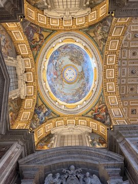 A breathtaking view looking up at the ornate, fresco-adorned interior dome of St. Peter's Basilica, capturing its intricate golden detailing and heavenly painted scenes. The image beautifully illustrates the post's sentiment by showcasing a magnificent architectural feature that, while stunning, often stands in the shadow of the basilica's more famous main dome—much like overlooked secondary characters among more celebrated peers.