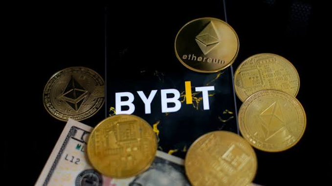Several gold Ethereum coins are arranged around a black surface displaying the 'BYBIT' logo, with a US dollar bill partially visible at the bottom.