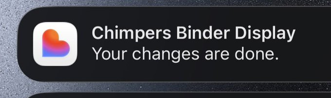 A notification from the 'Chimpers Binder Display' app displaying a gradient heart icon with the message 'Your changes are done.'