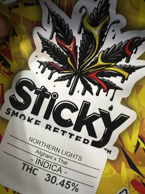 A 'Sticky Smoke Retted' cannabis label featuring a cannabis leaf with red and yellow accents, labeled 'Northern Lights Afghani x Thai - Indica - THC 30.45%'.