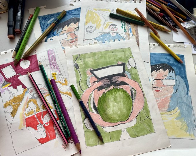 Several colorful children's drawings on white paper are spread across a surface, surrounded by an assortment of colored pencils and markers.