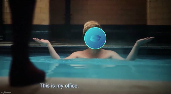 Meme image of a person in a swimming pool with arms outstretched, their face obscured by the Sandbox (SAND) crypto logo, with the caption 'This is my office.'