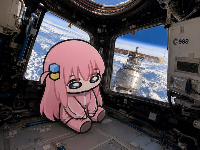 An anime-style pink-haired character sits inside a space station module, looking out the windows at Earth and a satellite, with an 'esa' logo visible on the interior wall.