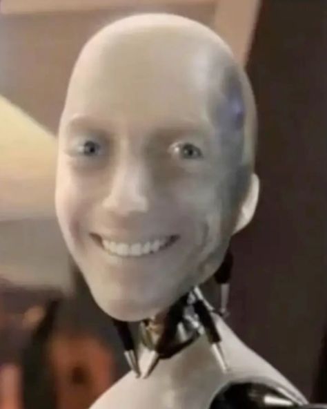 A close-up photograph of a smiling humanoid robot featuring a glossy, skin-like face and visible mechanical joints at the neck.