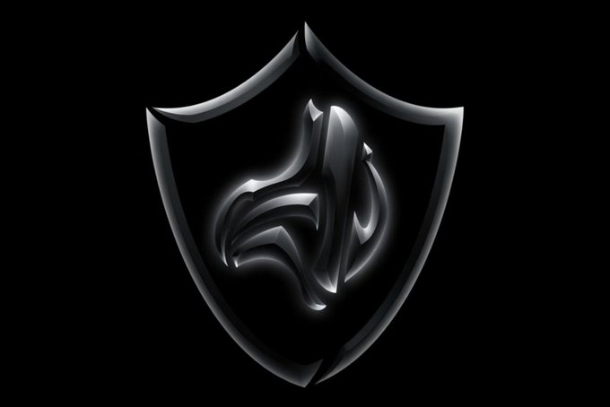 A metallic silver and black shield emblem with stylized letters resembling "JD" or similar monogram in the center, set against a black background.